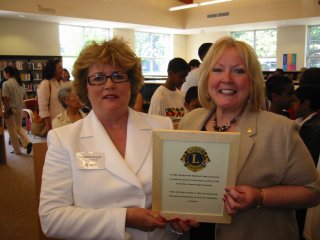 President Terry Fontana presents cheque to Michele Hull for pee wee baseball